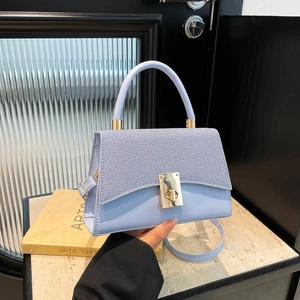 Stylish light blue handbag with woven texture flap and golden swivel clasp