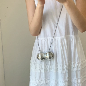 Mini silver peanut-shaped chain bag with metallic grain texture and sleek shoulder strap