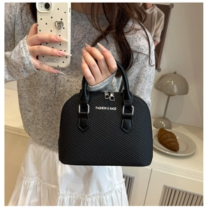 Detail showing the textured shell bag surface with white FASHION & BAGS lettering