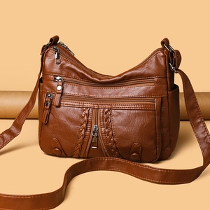 Caramel brown vintage faux leather crossbody bag with multiple zip pockets and woven detail