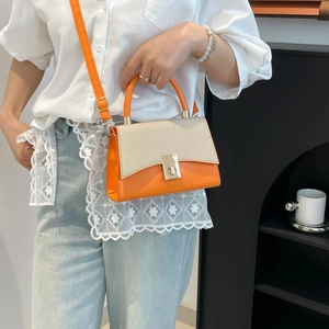 Contrast color orange and beige crossbody bag with woven flap and gold metal clasp