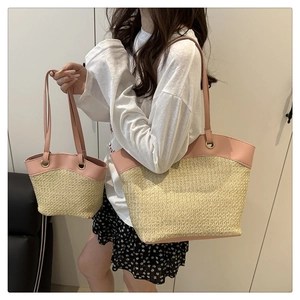 Detail of two-piece straw tote bag set with pink leather trim and metal eyelets