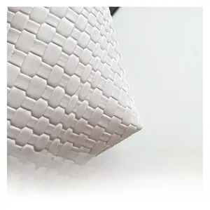 Close-up of premium white woven leather material showing high-end intrecciato craftsmanship