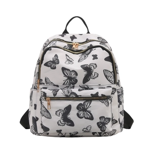 White butterfly print backpack for women featuring multiple zip compartments and gold hardware