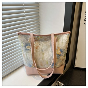 Detail of floral tapestry tote bag with blue tulip patterns and pink leather strap
