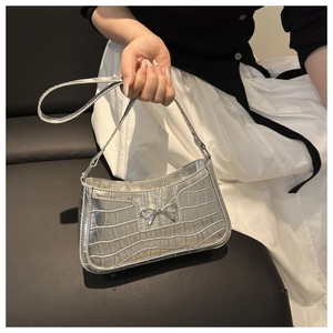 Silver crocodile pattern handbag featuring a metallic bowknot buckle and textured PU leather