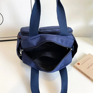 Large capacity dark blue nylon shoulder bag with multiple pockets and spacious interior
