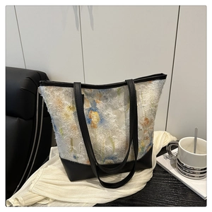 Floral chiffon tote bag detail featuring frayed edges and black leather handles