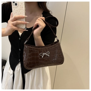 Mirror selfie showing the scale and styling of the dark brown crocodile pattern bag