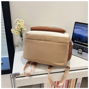 Detailed back view of tri-color canvas backpack with wide adjustable shoulder straps