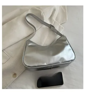 Detail of adjustable silver strap and buckle on the metallic crescent hobo shoulder bag