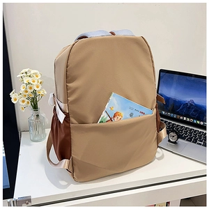 Detail of khaki and brown school backpack featuring side straps and breathable straps