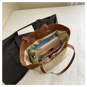 Detail view of large woven tote bag interior showing capacity with tablet and accessories