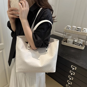 White woven tote bag featuring large capacity and stylish braided texture for women