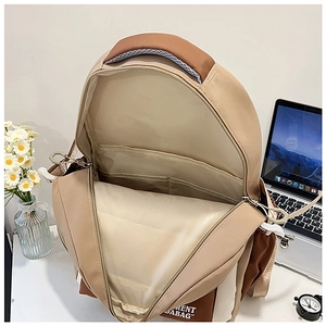 Top view of color-block backpack interior showing laptop compartment and multiple pockets