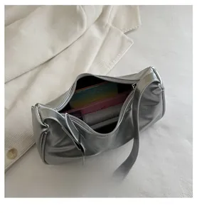 Interior view of silver crescent bag showing capacity for books and daily essentials
