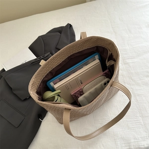 Large beige woven tote bag for women showing spacious interior with daily essentials