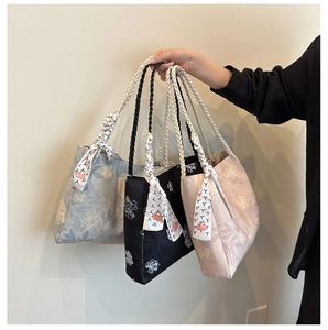 Detail view of printed canvas tote bags in blue black and pink with woven rope handles