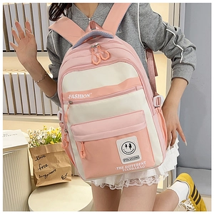 Detail view of pink and white vintage style backpack showing side pockets and fabric texture