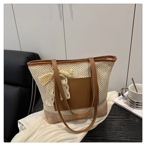 Detail of woven straw tote bag featuring leather pocket and delicate lace bow decoration