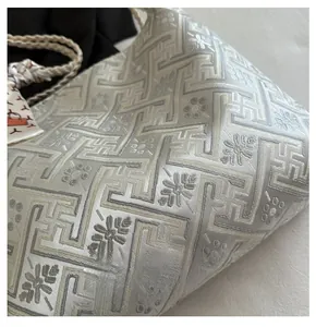 Close-up of geometric jacquard fabric and floral patterns on the tote shoulder bag