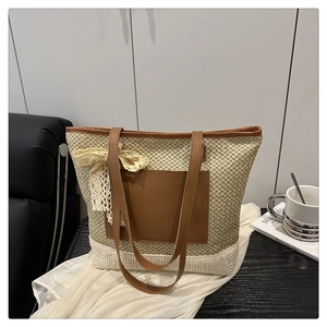 Detail of woven straw tote bag with brown leather pocket and elegant lace bow decoration