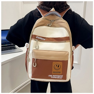 Model wearing a three-color panel backpack with large capacity and multi-pocket design