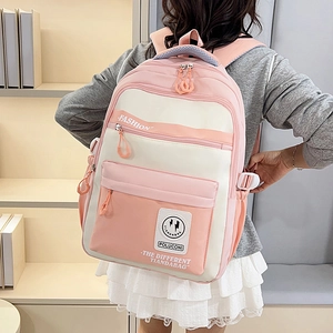 Pink and beige colorblock student backpack with multiple zippers in a school setting