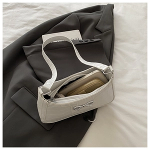 Detail of white crocodile embossed shoulder bag interior showing spacious capacity