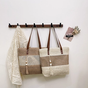 Large woven straw tote bags for summer beach trips with leather handles and tassel charms