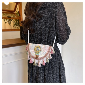 Detailed close-up of a bohemian crossbody bag with colorful tassels and bead embroidery