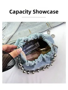 Detailed interior of a blue denim bucket bag showing lipstick and cosmetic storage