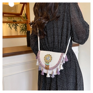 Detailed back view of a white bohemian crossbody bag with colorful beadwork and tassels