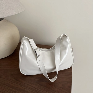 Minimalist white faux leather crescent hobo bag with adjustable silver hardware shoulder strap