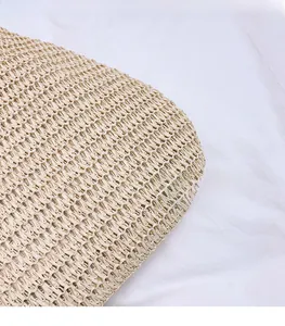 Detailed close-up of light beige woven straw texture and breathable handcraft material