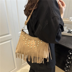 Chic tan faux suede crossbody bag featuring gold rivets and long tassels decoration
