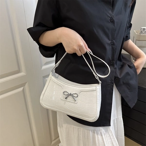 White crocodile pattern underarm bag with silver bow accent and crescent shape for women