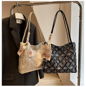Detail of jacquard tote bags in black and silver gray with woven rope handles