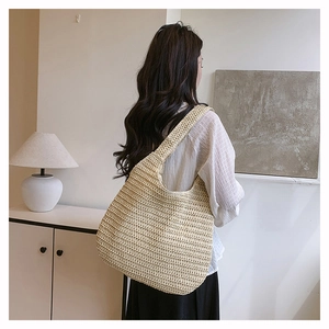 Detail of hand-woven straw texture and large capacity on beige summer tote bag