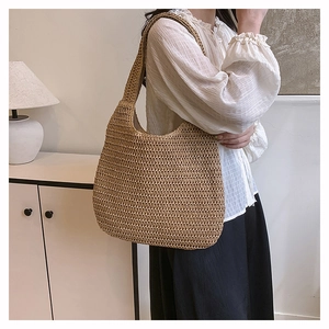 Detail shot of the large woven tote bag showing texture and wide shoulder strap
