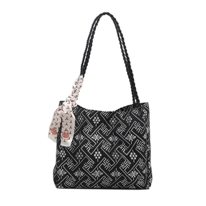Ethnic style black tote bag with white geometric patterns and silk scarf handle