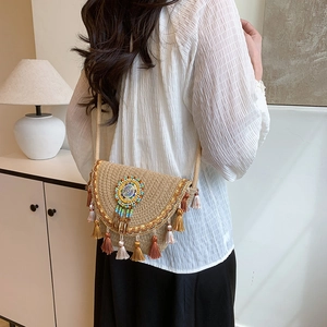 Bohemian woven straw crossbody bag with ethnic embroidery and colorful long tassels