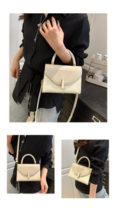 Detail showing beige woven texture flap and golden lock on a chic crossbody bag