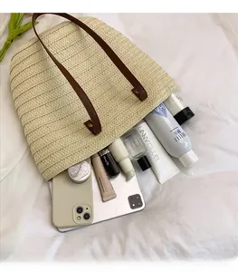 Top view of woven tote bag showing large capacity with phone and cosmetics inside