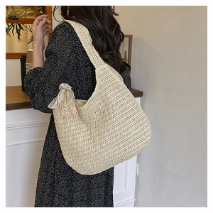 Close-up of beige woven shoulder bag featuring lace bow detail in a cozy cafe setting