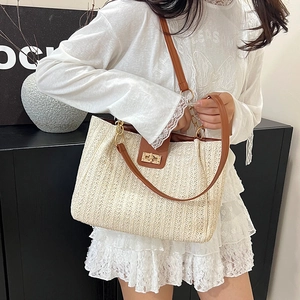 Large capacity woven straw tote bag with brown faux leather straps and metal lock closure
