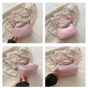 Detailed views of pink crescent bag with glitter texture, pearl chain and ribbon straps
