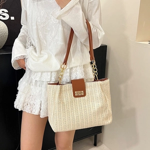 Chic woven straw tote bag with brown leather flap and chain strap for summer beach fashion