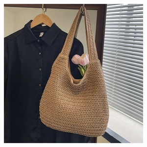 Close-up of beige woven beach bag texture with pink tulips and natural window lighting