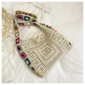 Detail of bohemian crochet tote bag featuring colorful sunflower granny square patterns